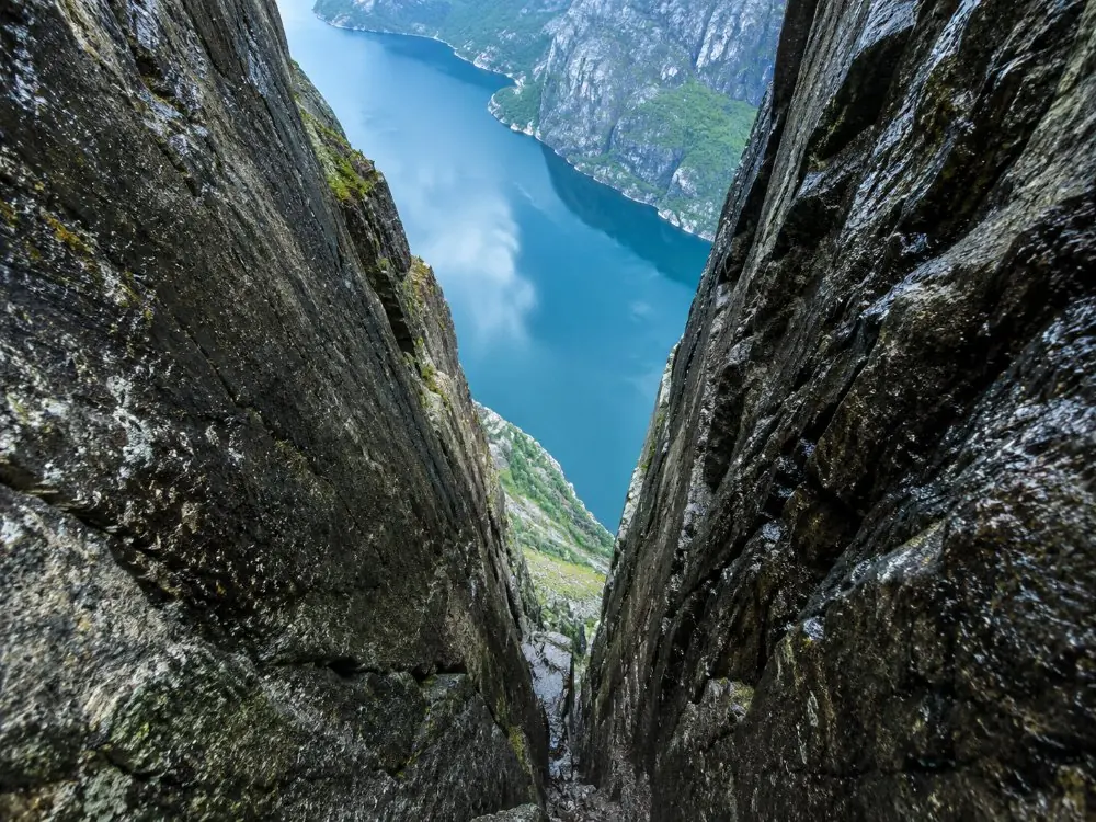 The narrow rock crevice holding Kjeragbolten, with the drop to the fjord below