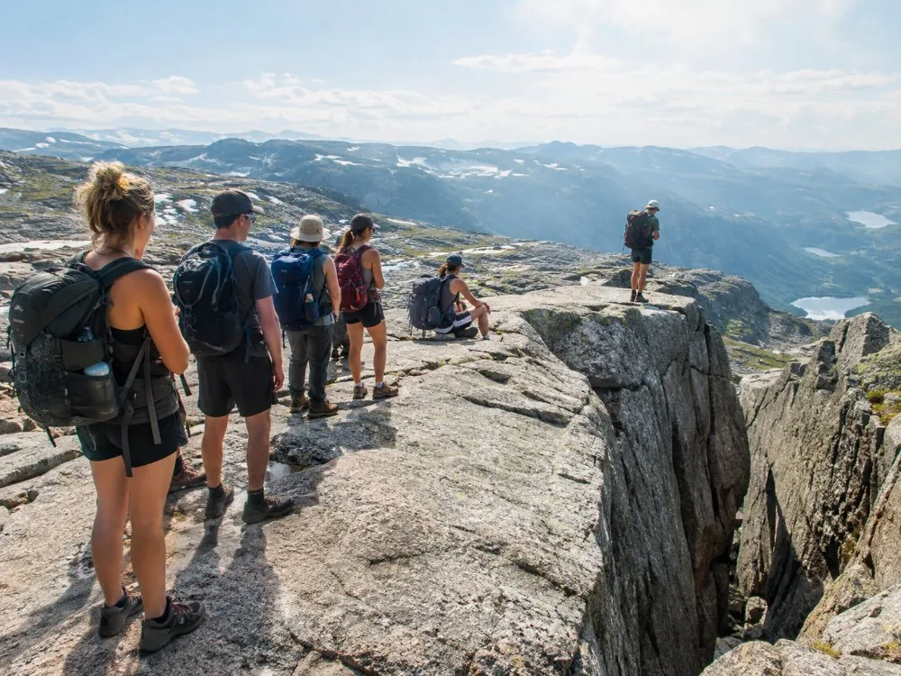 Walkers waiting their turn for a photograph beside Kjeragbolten on a busy afternoon